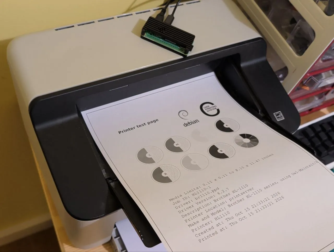 A Brother HL-1110 printer with a Raspberry Pi Zero 2 W connected to it